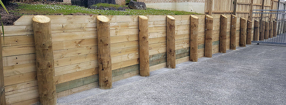 timber fence retaining wall being built in auckland